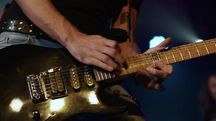 Musician playing electric guitar slow motion close up