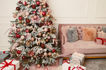 A festive holiday scene featuring a stunningly beautifully decorated Christmas tree adorned with...