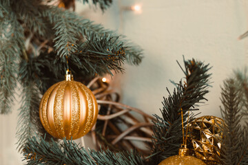 This elegant depiction of golden Christmas ornaments on a lush pine branch captures the joyful...