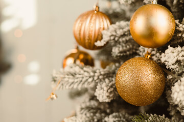 The Elegant Gold Christmas Ornaments on a Frosty Tree create a warm, festive atmosphere that brings...