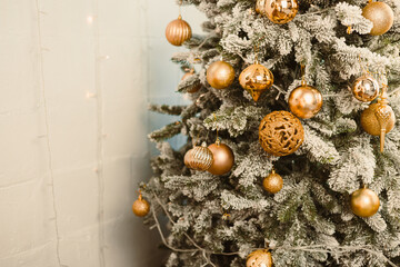 A Beautifully Decorated Christmas Tree adorned with Shiny Gold Ornaments and Snowy Foliage, perfect for enhancing Festive Celebrations and bringing joy to your home this holiday season