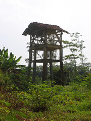 View of an abandoned tower house in the farmland on a sunny day. 