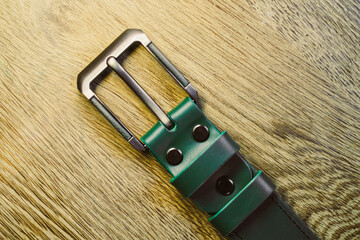 This sophisticated stylish green and gray leather belt features a sleek metal buckle and is...