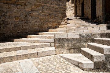 Stone steps and rustic wall textures in medieval village setting, Valderrobres, Aragon, Spain, architectural rhythm and historic atmosphere