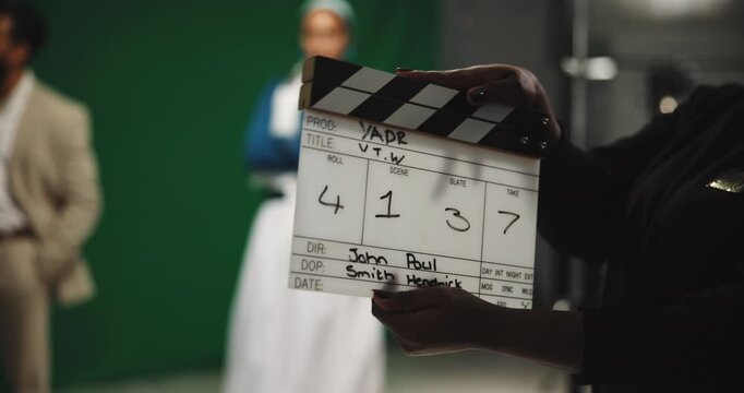 Production, people and movie slate for shoot, actor and process in studio, art or behind the scenes. Media, team and clapperboard for visual cue, creative and director with equipment for filming
