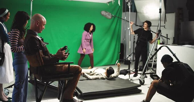 Woman, man and fight with film set, cameraman and recording for action, shoot and director. People, actress and cinematography with creativity, performance and production staff for movie at studio