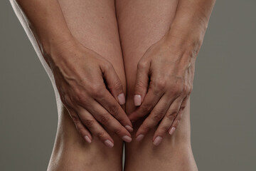 Close Up of Two Hands Resting on Bare Knees