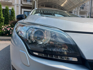 This captivating CloseUp image of a car headlight highlights its intricate design, blending style...