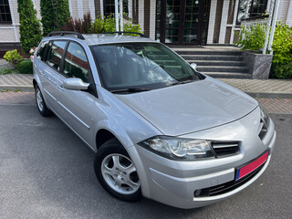 A stylish silver compact station wagon with a sleek and modern design is parked gracefully in front...