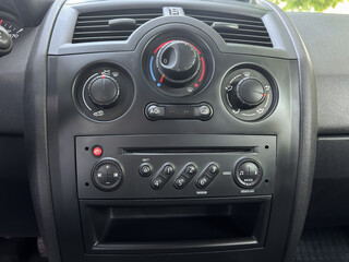 A closeup view showcasing the intricate design of modern car dashboard controls, which prominently...