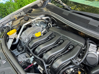 A HighPerformance Engine Compartment with a sleek Black Intake Manifold and vibrant Yellow Caps,...