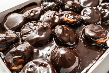 Classic profiteroles coated in rich, glossy dark chocolate sauce