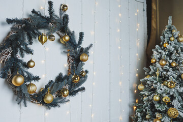 A beautifully festive Christmas wreath hangs proudly on the door, while a decorated tree stands...