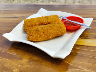 Crispy golden rissoles with savory and delicious filling, served on an elegant white plate,...