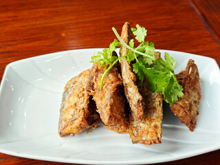 dry fried ribbon fish  with vegetables on the white plate