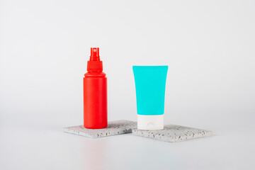 Plastic white tube for cream or lotion. Skin care or sunscreen cosmetic, Cosmetic red bottle....