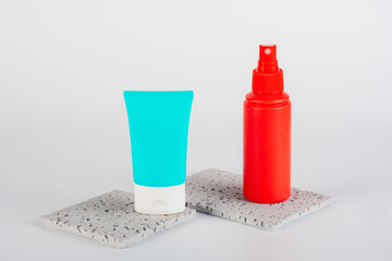 Plastic white tube for cream or lotion. Skin care or sunscreen cosmetic, Cosmetic red bottle....