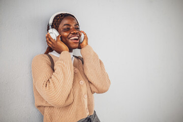 Portrait of young black woman who is messaging on smartphone.
