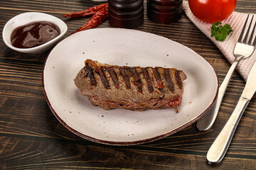Grilled beef striploin steak with sauce