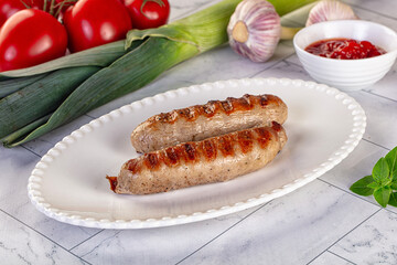 Grilled pork sausages served tomato sauce
