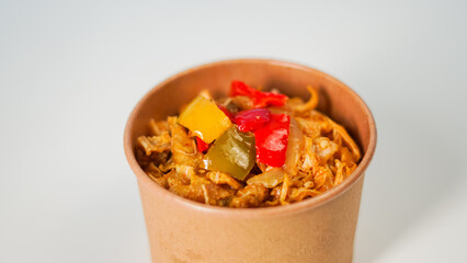 Delicious Stir-fried Noodles with Bell Peppers in a Brown Paper Bowl