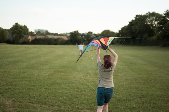 Young girl playing with a kite. Flying the kite, summer time