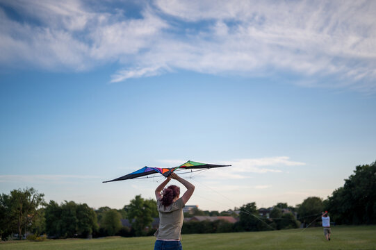 Young girl playing with a kite. Flying the kite, summer time