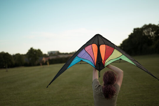 Young girl playing with a kite. Flying the kite, summer time
