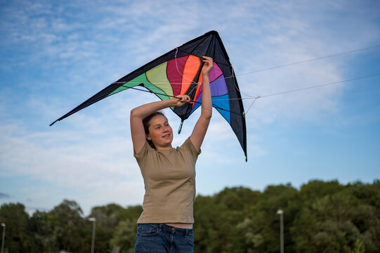 Young girl playing with a kite. Flying the kite, summer time