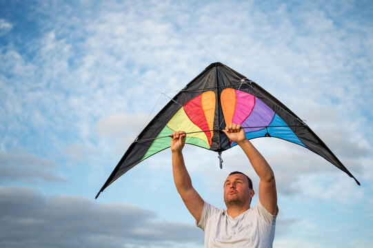 A man holding a kite, summer hobby, outdoor activity