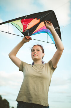 Young girl playing with a kite. Flying the kite, summer time