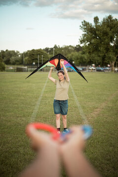Summer outdoor activities. Girl flying a kite in the park