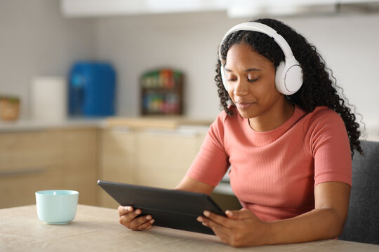 Black woman watching media content in a digital tablet