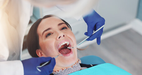 Dental mirror, oral health and dentist with woman for treatment of tooth decay, cavity or checkup....