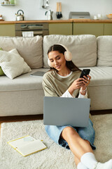 Young woman enjoys a cozy afternoon at home while multitasking on her devices