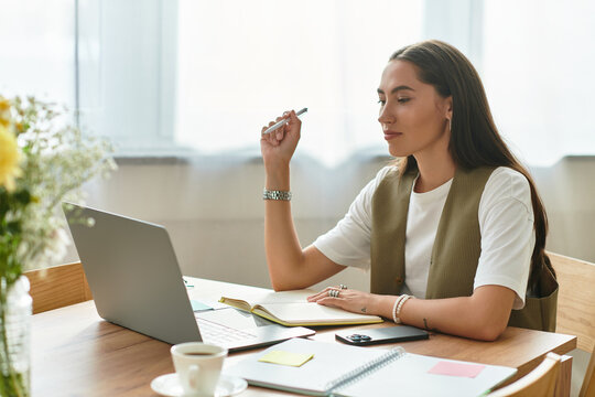 Young beautiful woman enjoying a cozy afternoon at home while working on her laptop