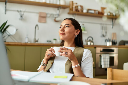Young pretty woman enjoying a cozy moment with coffee at home on a sunny afternoon