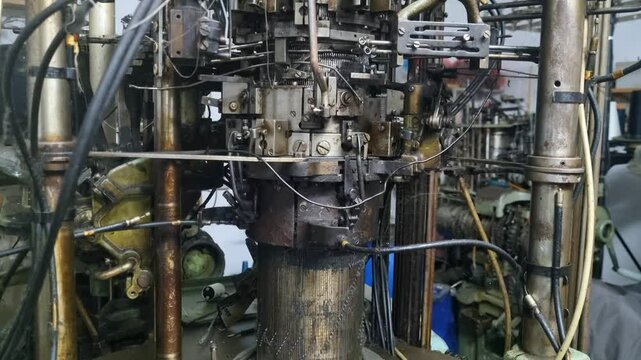 Close-up of a vintage 1950s sock knitting machine from Yugoslavia&rsquo;s former textile industry, showcasing the intricate art of mechanical engineering