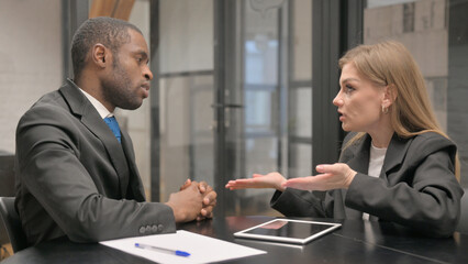 Angry Businesswoman Talking with African Businessman at Work