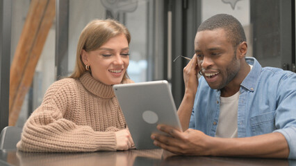 Multi Ethnic People Celebrating Success on Tablet