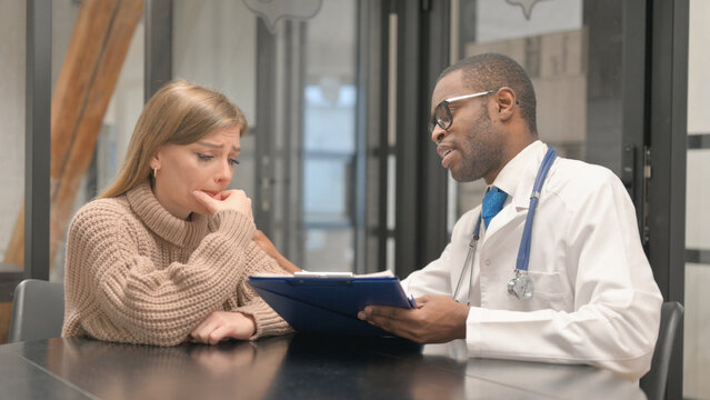 Patient Feeling Upset after Bad News by African Doctor, Discussing Medical Report
