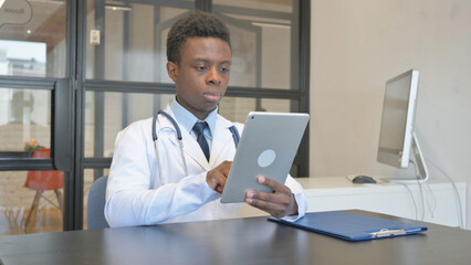 African Male Doctor Using Digital Tablet