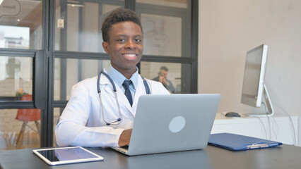 African Male Doctor Smiling at Camera in Hospital