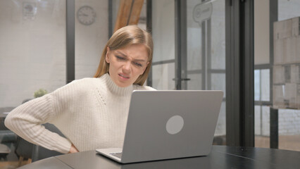 Creative Young Woman having Back Fatigue and Pain at Workspace