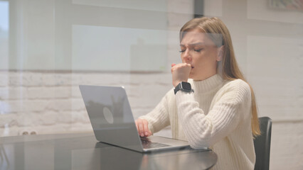 Sick Female Employee Coughing at Workspace