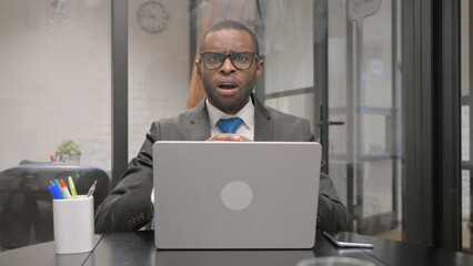 Working African Businessman Shocked while Looking at Camera