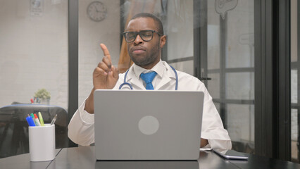 Displeased African Male Doctor Denying while Looking at Camera