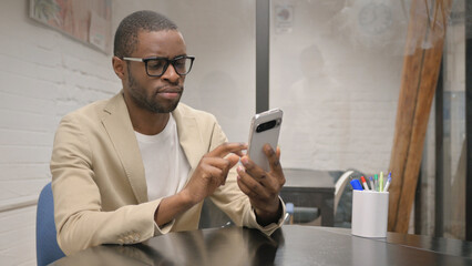 African Man Browsing Internet on Phone