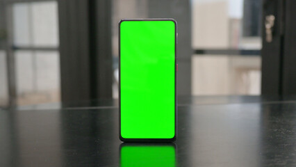 Phone with Green Screen on Desk