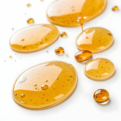 Golden, glistening honey serum drops suspended on a white background, symbolizing purity, skincare luxury, and the natural essence of nourishment.